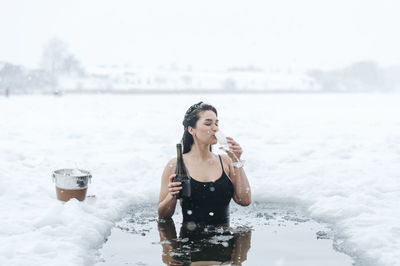 Portrait of young woman swimming in sea