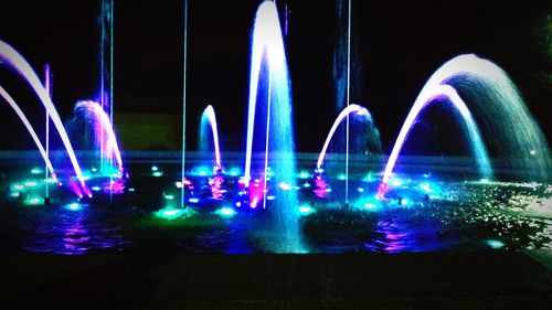 Illuminated fountain at night