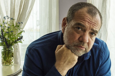 Pensive man in a room at home