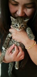 Close-up of woman holding cat