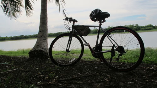 Bicycle on field against sky