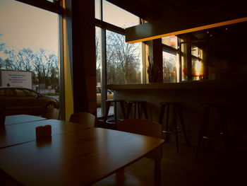 Empty chairs and tables in restaurant