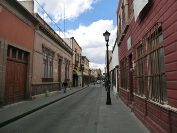 Street amidst buildings in city against sky