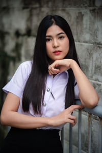 Portrait of a beautiful young woman standing outdoors