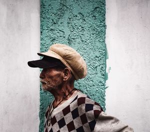 Portrait of man standing against wall