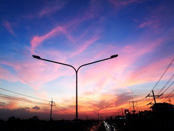 Low angle view of silhouette street against sky during sunset