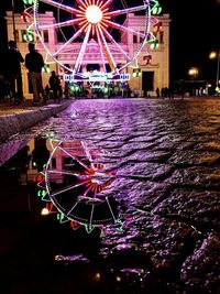 Illuminated ferris wheel at night