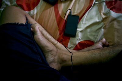 Midsection of man using mobile phone