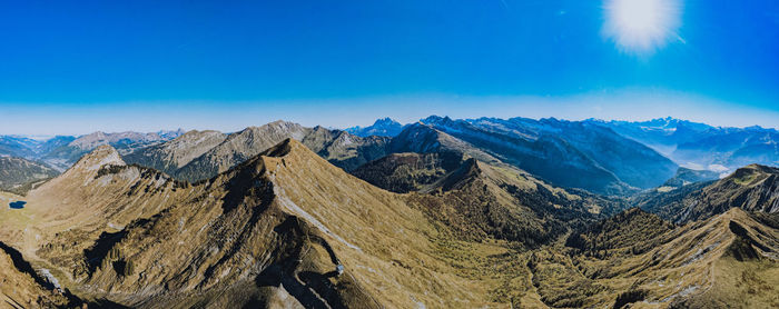 Panoramic view of mountains against blue sky