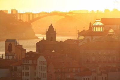 View of buildings in city at sunset