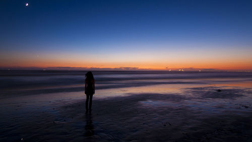 People on beach at sunset