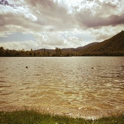 Scenic view of lake against dramatic sky