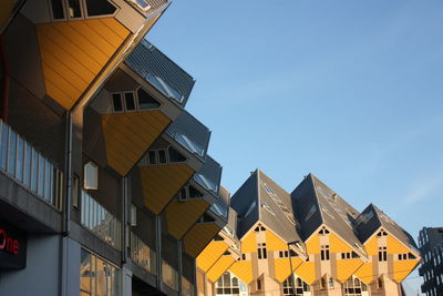 Low angle view of buildings against blue sky