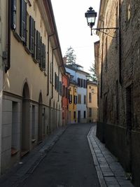 Street amidst residential buildings against sky