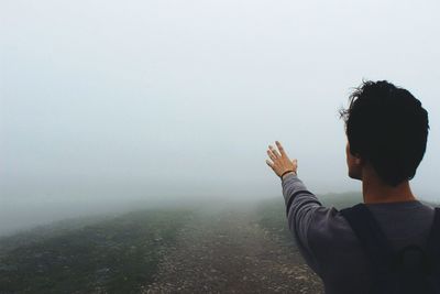 Woman standing in foggy weather