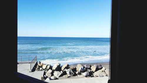 Scenic view of sea against clear blue sky