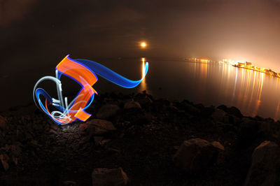 Light painting at sea shore during night