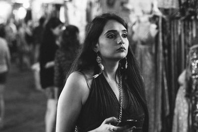 Young woman looking away in the market walking in goa, india