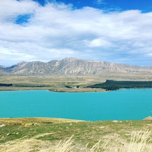 Scenic view of lake against cloudy sky