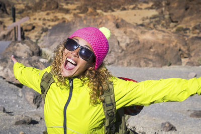 Portrait of woman wearing sunglasses standing outdoors