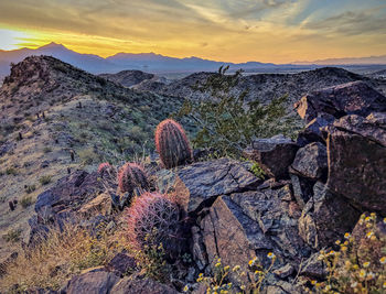 Scenic view of rocky mountains against sky during sunset