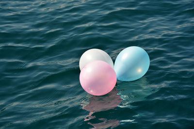 High angle view of balloons floating on sea