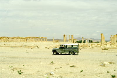 Car on landscape against sky