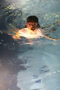 Close-up of wet man swimming in pool