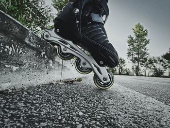 Low section of man riding bicycle on road