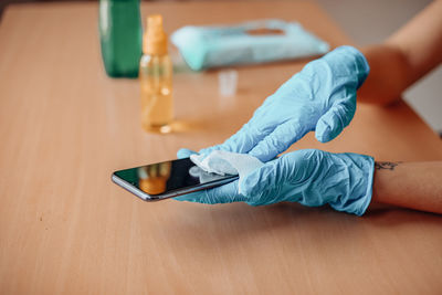 High angle view of woman hand on table