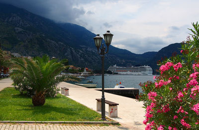 Scenic view of sea by mountains against sky