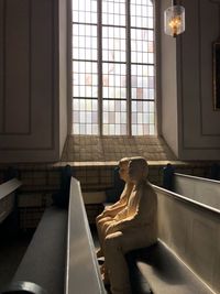 Man sitting by window at home