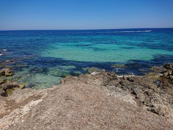 Scenic view of sea against clear blue sky