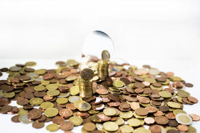 Close-up of coins on table against white background