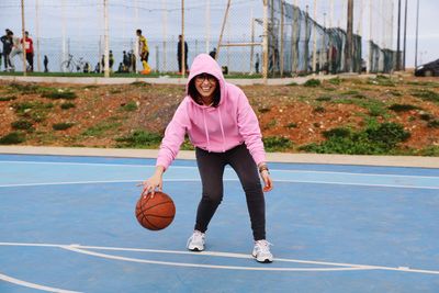 Low angle view of woman playing with ball