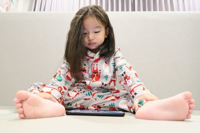 Portrait of cute girl sitting at home