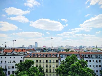 View of cityscape against cloudy sky