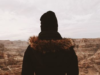 Rear view of man at grand canyon national park against sky