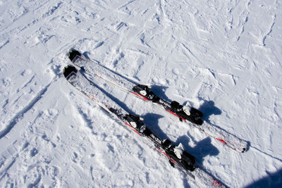 High angle view of skis on snow field