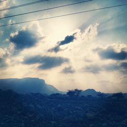 Scenic view of mountains against cloudy sky