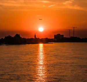 Scenic view of sea against orange sky