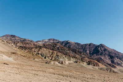 Scenic view of mountains against clear blue sky