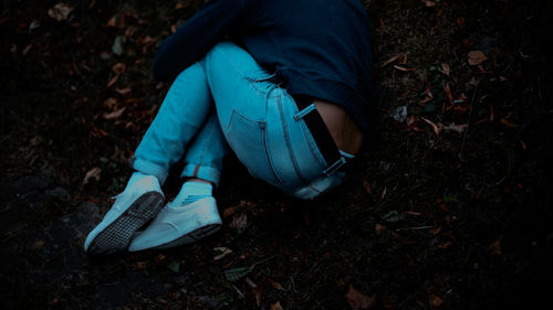 Low section of person lying on field