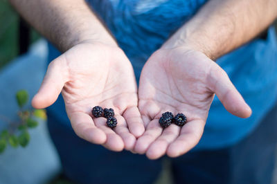 Midsection of man holding fruits