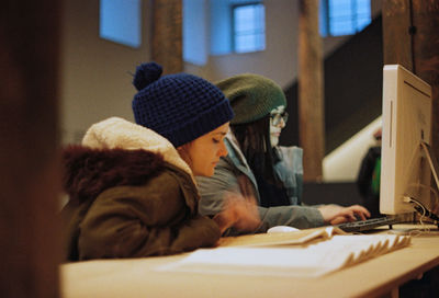 Side view of woman using laptop