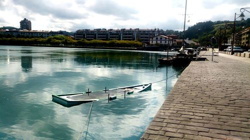Boats in river with buildings in background