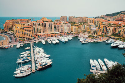 High angle view of buildings by sea against clear sky