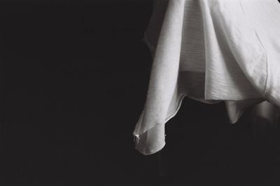 Low section of woman standing against black background