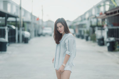 Young woman standing on the road in city