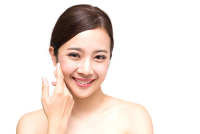 Portrait of a smiling young woman over white background